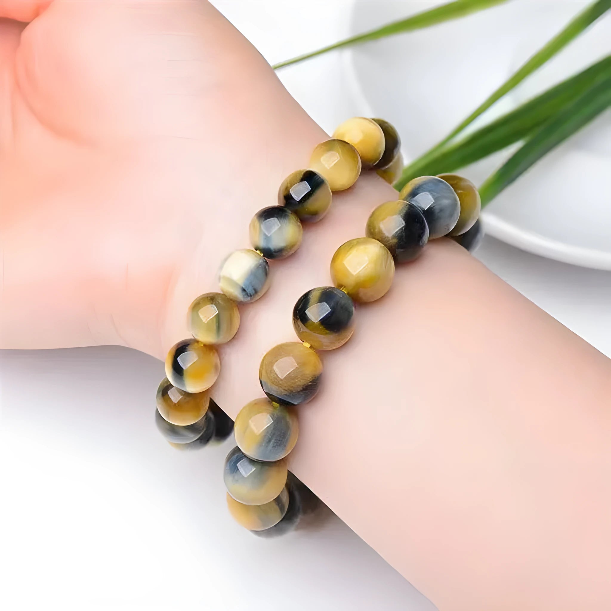 Fantasy tigereye agate bracelet with round beads on a wrist, showing natural stone patterns.