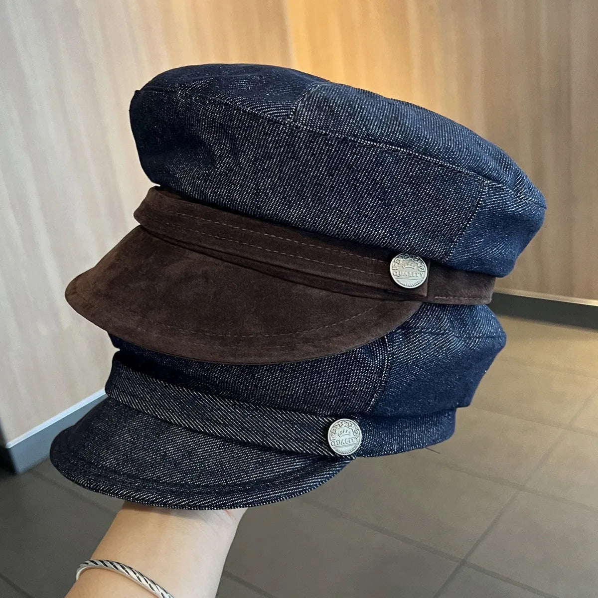 Dark blue denim newsboy hat with octagonal retro design and adjustable sizing