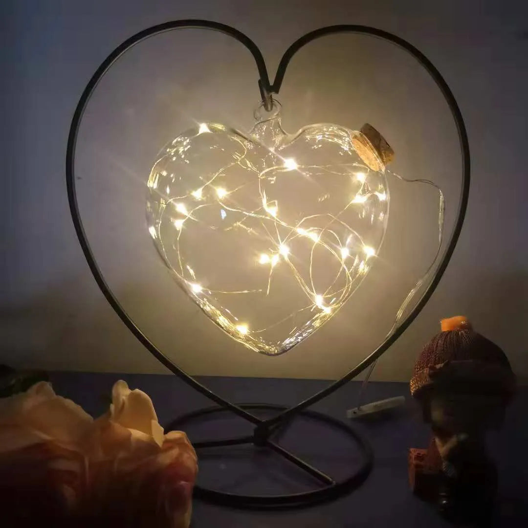 Round glass wish bottle with cork, 12 cm diameter, containing a warm white LED light strand with 20 lamp beads and folded paper stars