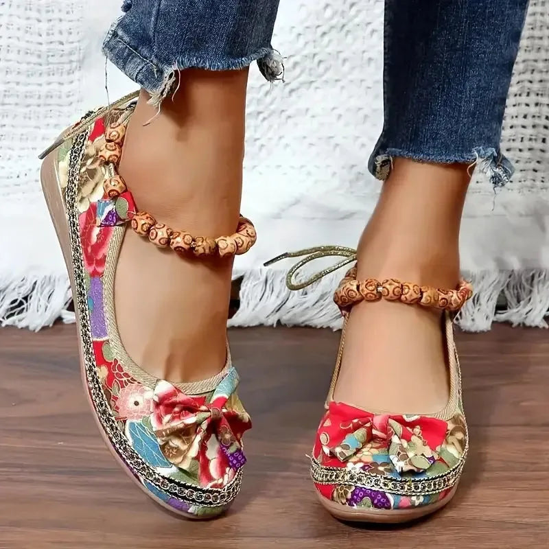 Women's black ethnic platform sandals with elastic band and cloth upper on a plus-size foot.