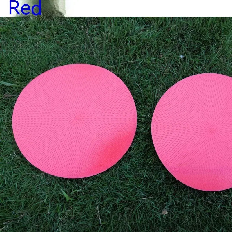 Yellow football training marker disc on grass field showing 23cm diameter flat design