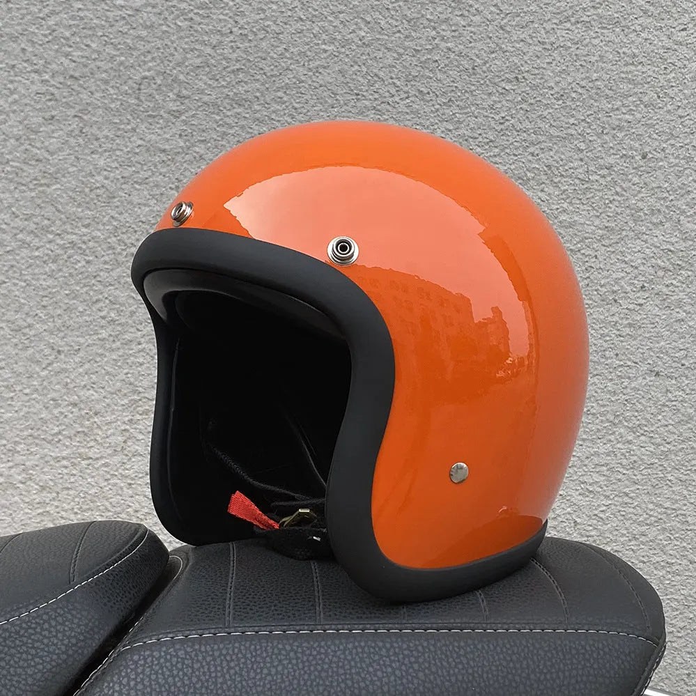 Retro-style open-face motorcycle helmet in fibreglass, shown in a choice of colours including Cement Grey and Matte Black Flower.