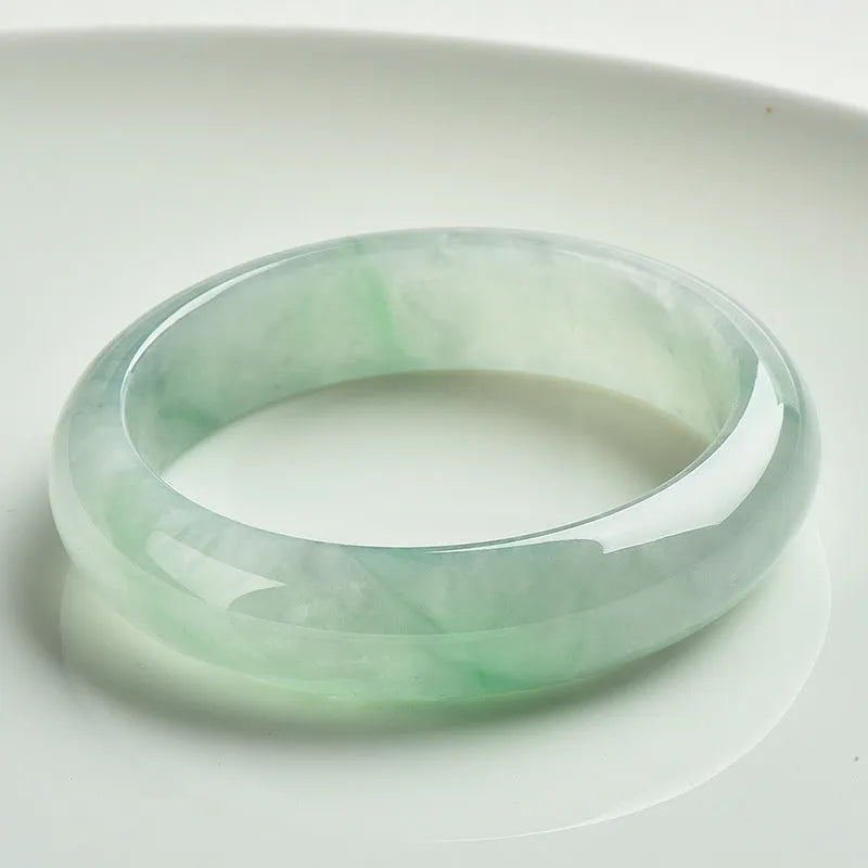 Light green jade bracelet on wrist showing natural stone texture and colour