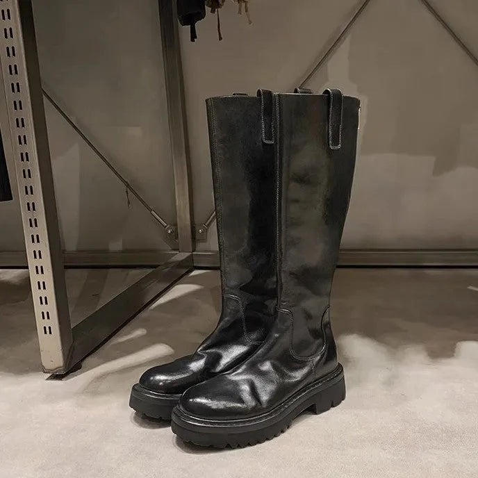 Black chunky heel knight boots with round toe and high shaft, showing the back zip detail.