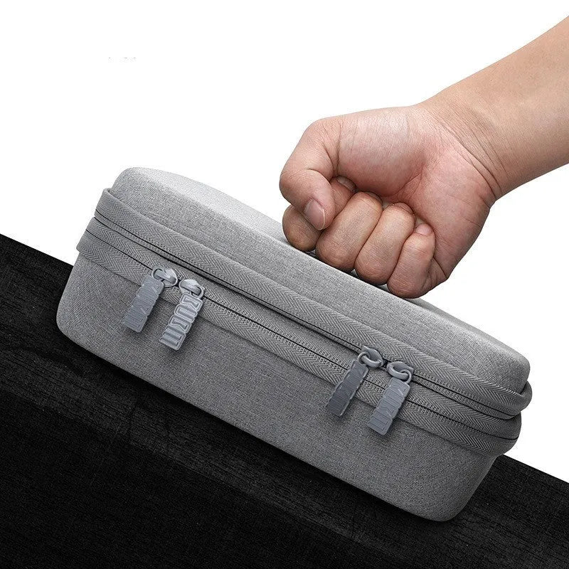 Black EVA digital storage bag for organising headphones and cables on a desk