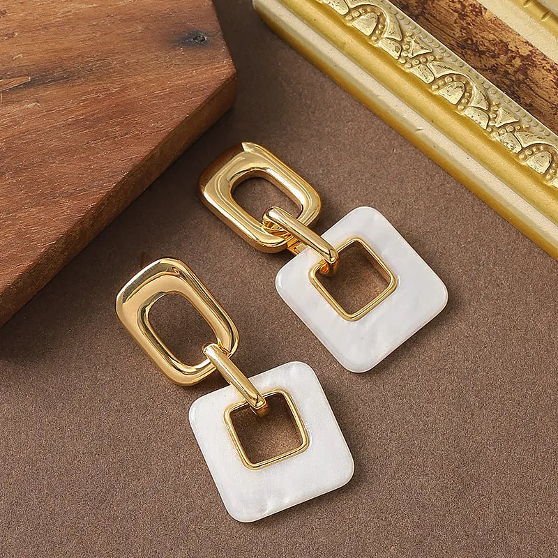Hollow geometric square earrings with chamfered corners in electroplated copper