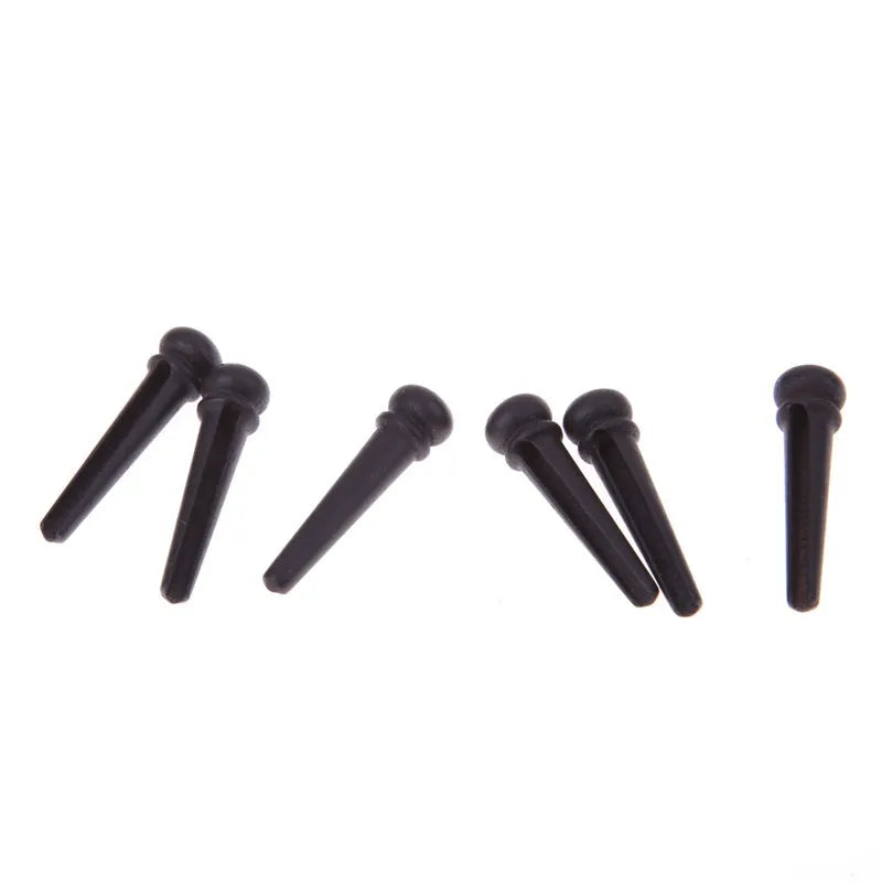 Six ebony folk guitar string nails with 5.3mm bayonet diameter in matt black finish