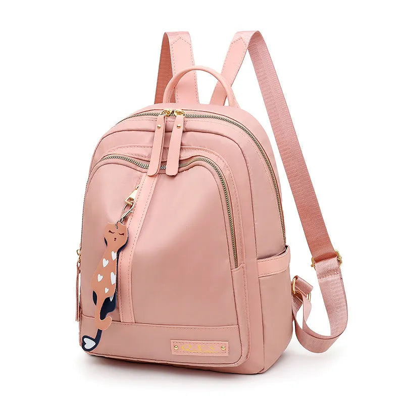 Black and pink casual nylon backpack with double straps, soft handle, and external pocket.