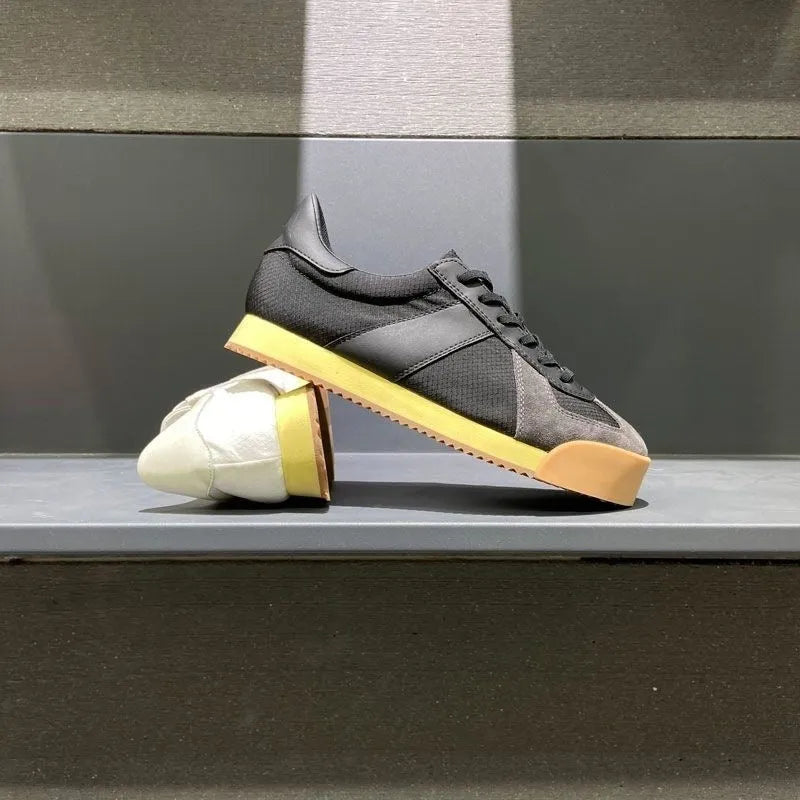 Men's black cow suede leather sports shoes with mesh panels and a raised sole.