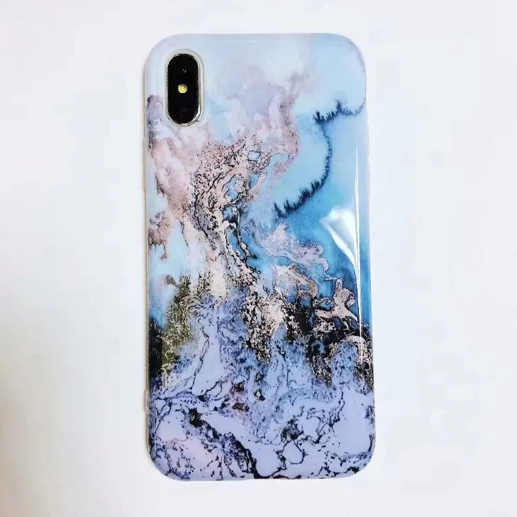 Colourful stone pattern soft protective case for iPhone X, 8, 7, 6, and 6s Plus models on a table.
