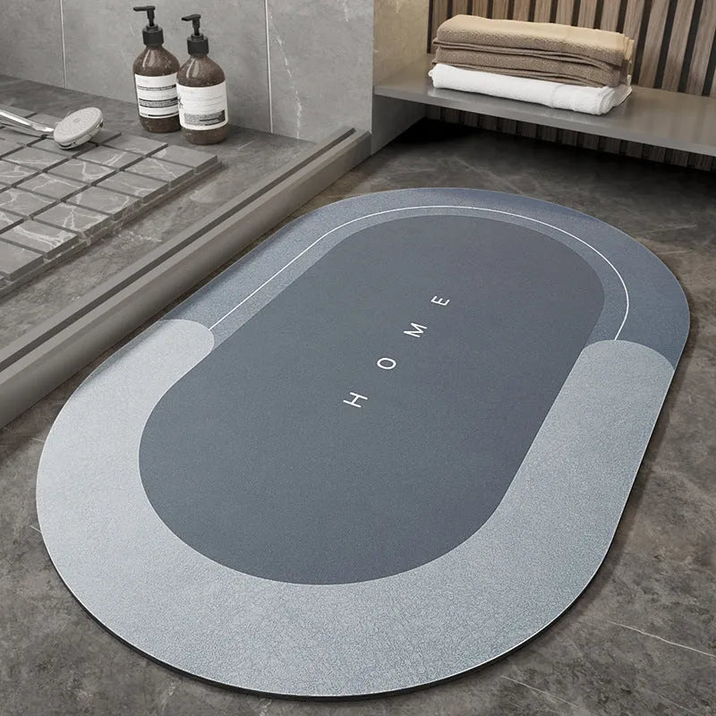 Machine-woven blended bathroom floor mat in blue, shown in an oval shape on a tiled floor.