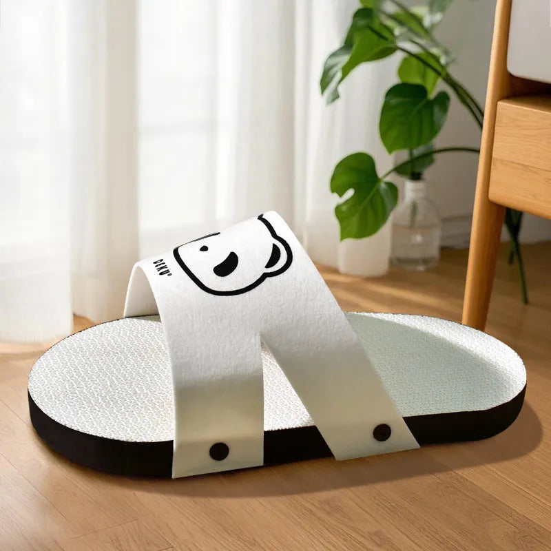 White slipper-shaped corrugated paper cat scratch board on a floor