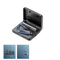 Black Bluetooth earphones with a charging warehouse case and silicone ear caps on a table.