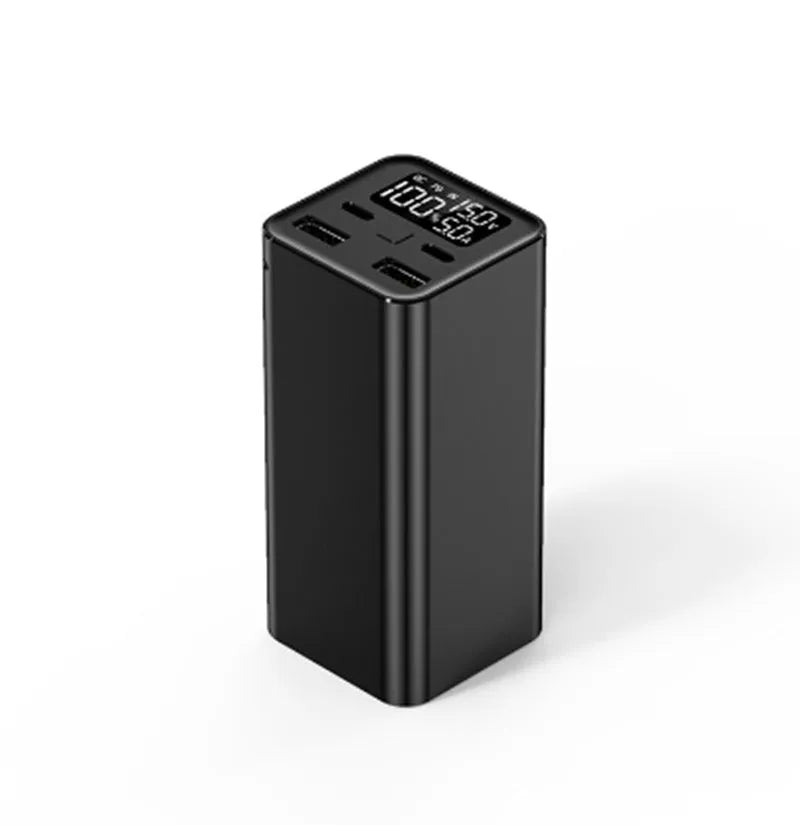 Black metal 65W laptop power bank with 20000mAh capacity showing size next to a laptop.