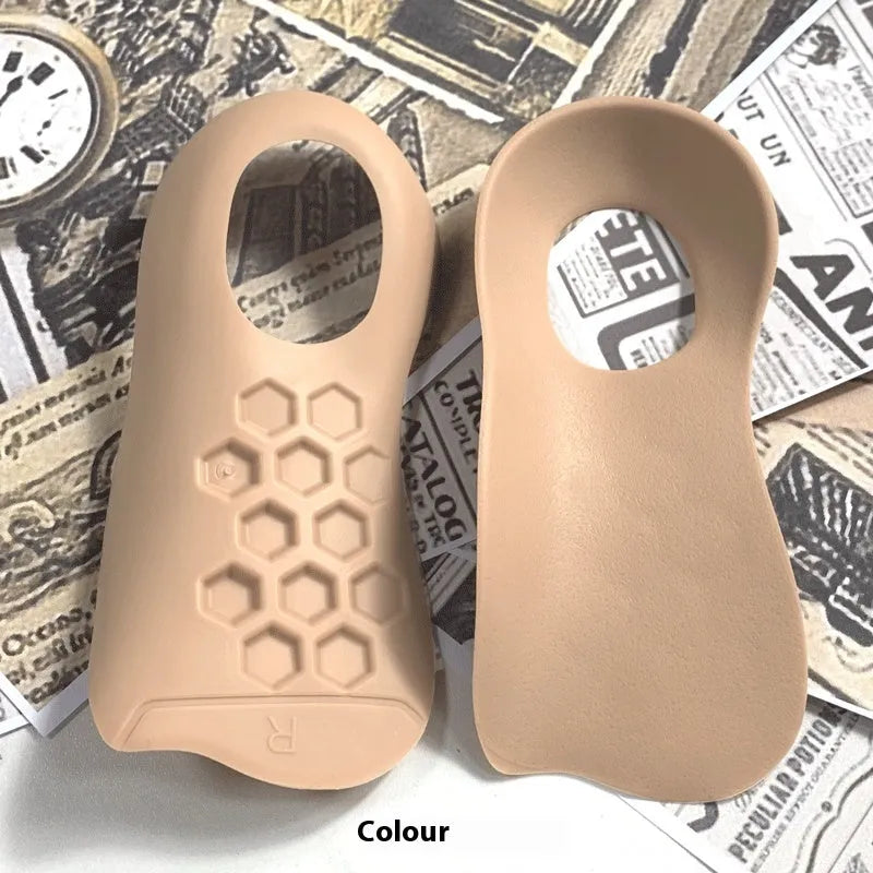White arch support insole for varus foot correction on a grey background.
