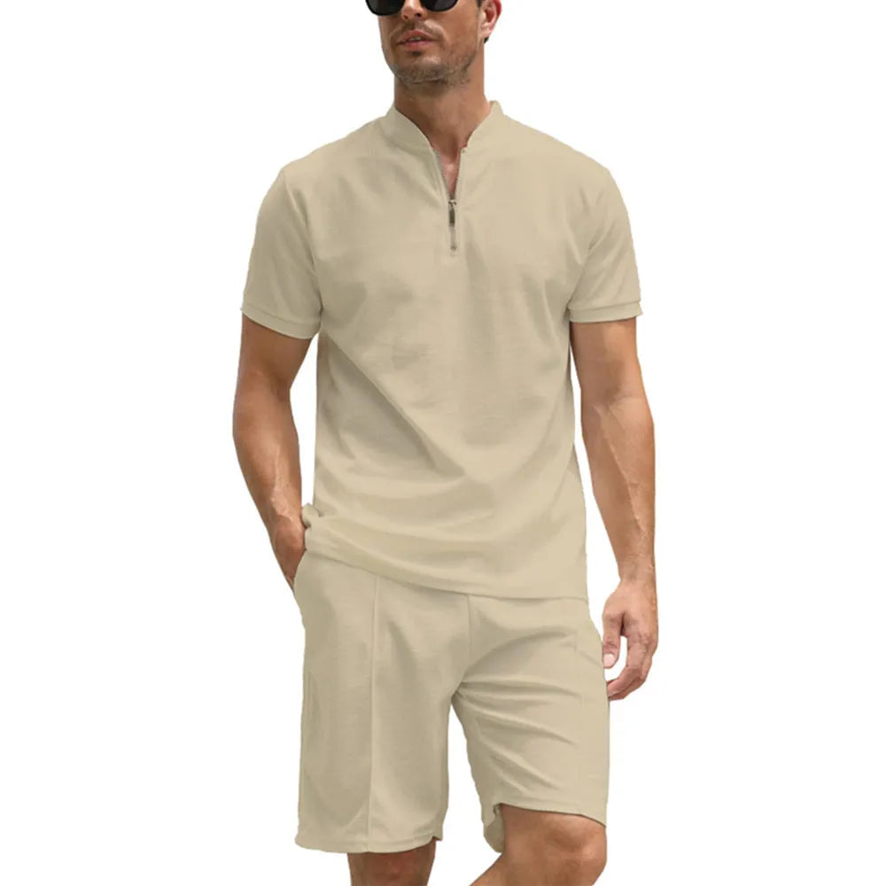 Men's solid colour polo shirt and trouser two-piece set in textured fabric.
