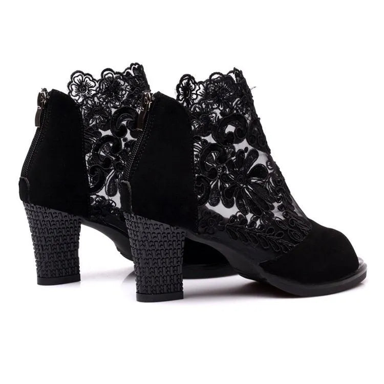 Black women's gladiator sandals with flower lace upper, square heel, and back zip closure.
