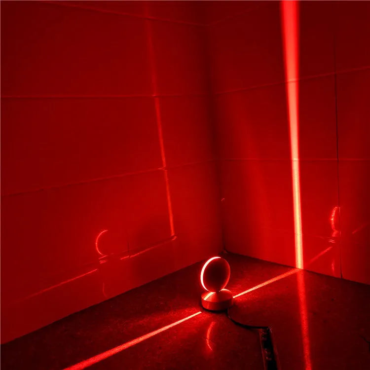 Modern aluminium spotlight bar wall lamp with glass lens, mounted on a wall.