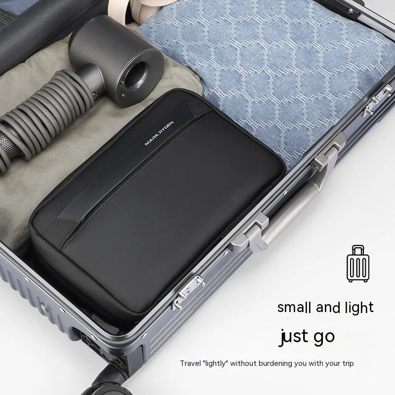 Black Oxford cloth toiletries bag with multiple compartments open, showing wet-dry separation design.