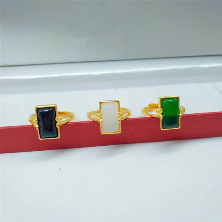 Gold-plated brass adjustable ring with a choice of black, green, or white gemstone inlays.
