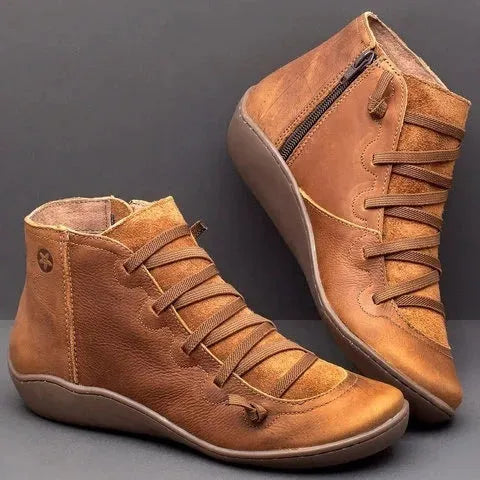 Women's black casual flat booties with a wedge heel and round toe on a rubber sole.
