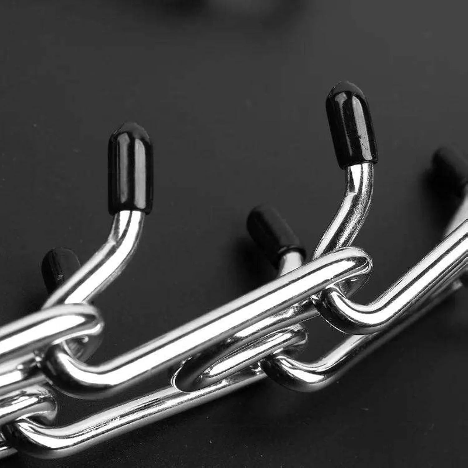 Stainless steel dog prong training collar with rubber tips and adjustable chain links.