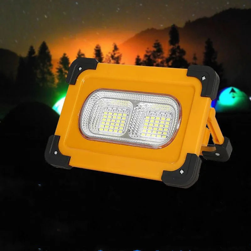 Yellow outdoor portable solar LED light with power bank and magnetic base, 36LED lamp beads model 5730, sitting on a metal surface
