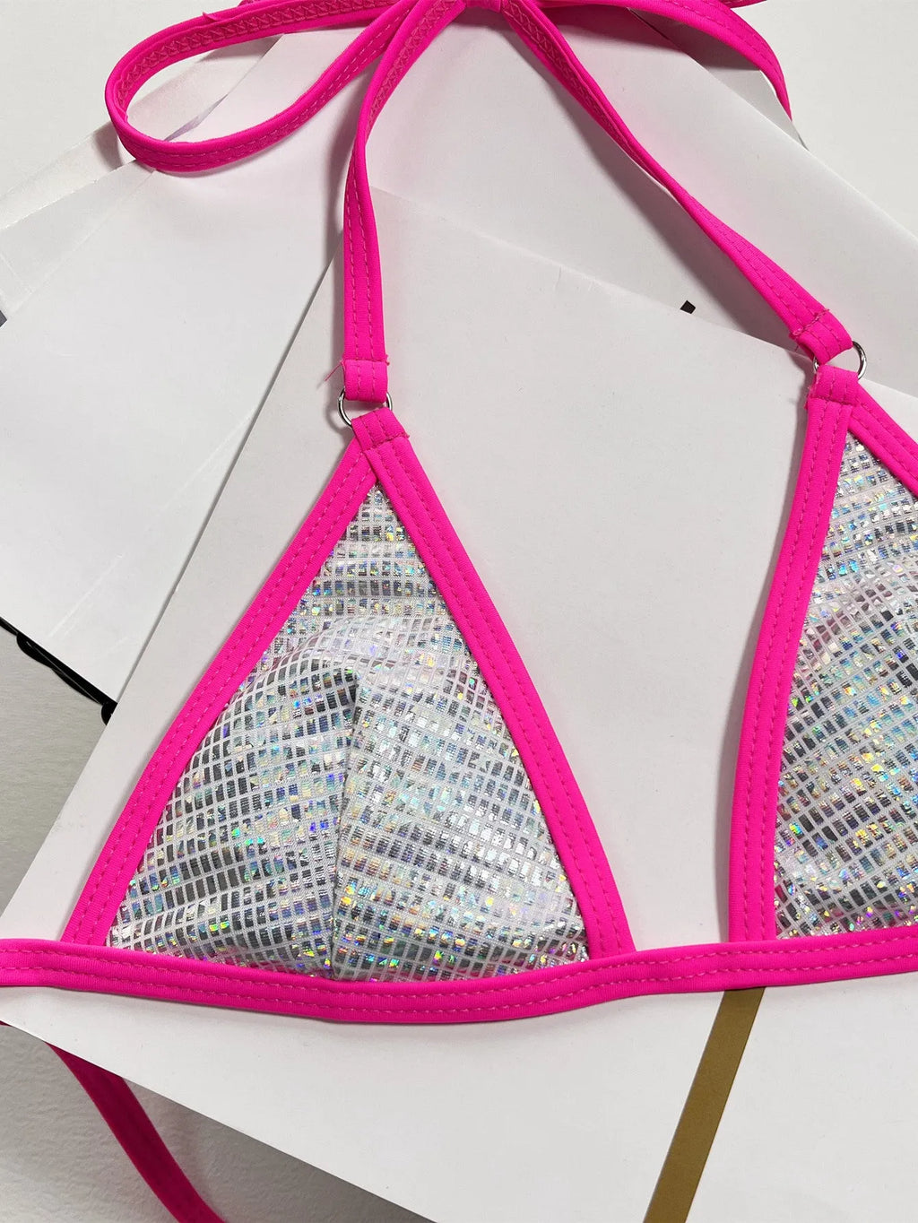 Silver one-piece women's swimsuit with a split triangle bag design on a mannequin.