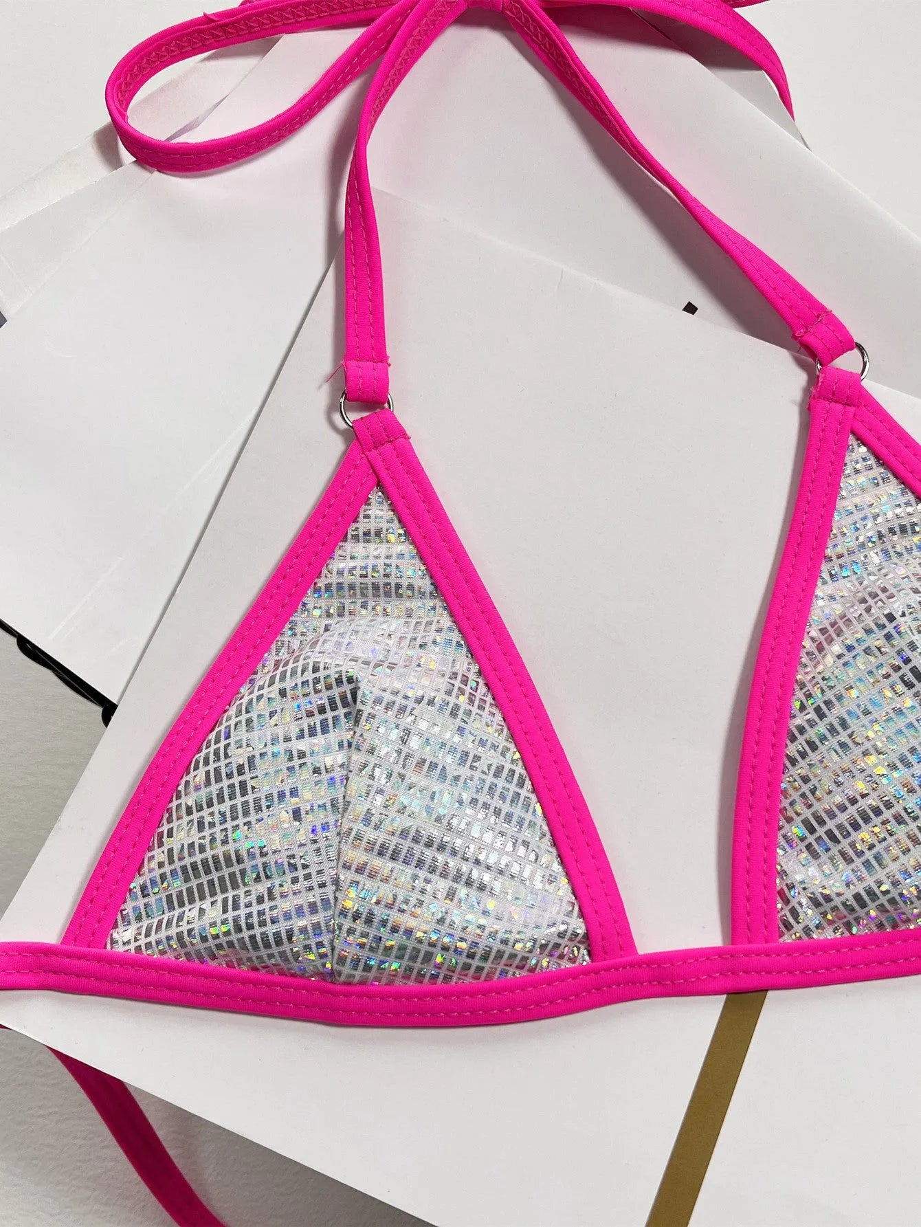Silver one-piece women's swimsuit with a split triangle bag design on a mannequin.