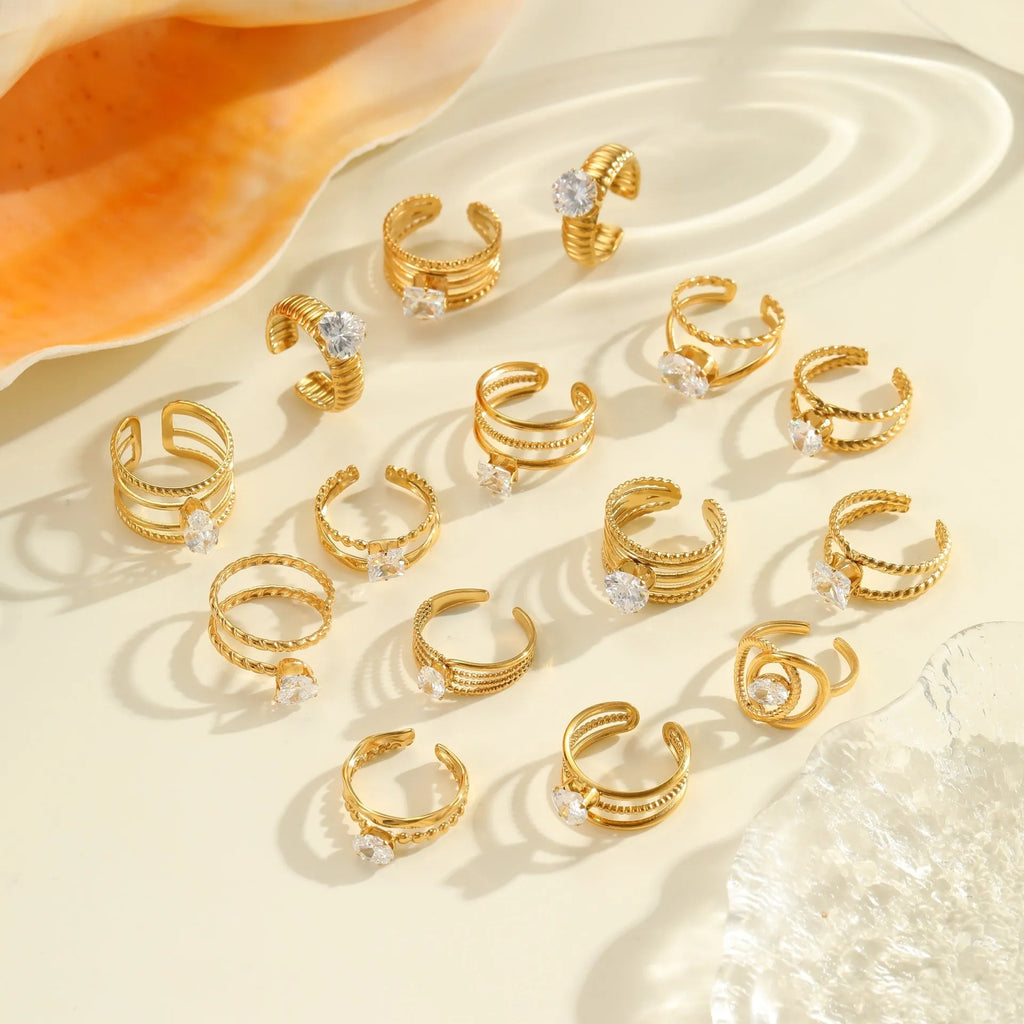 Gold electroplated adjustable ring with geometric zircon design on a stainless steel band.