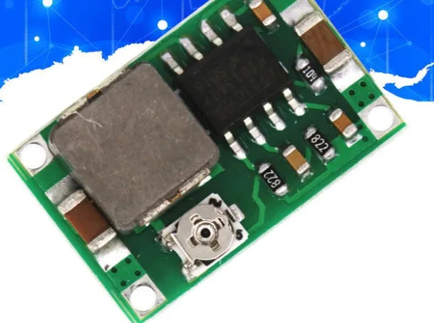 Mini-360 green DC-DC buck converter step-down power module on white background