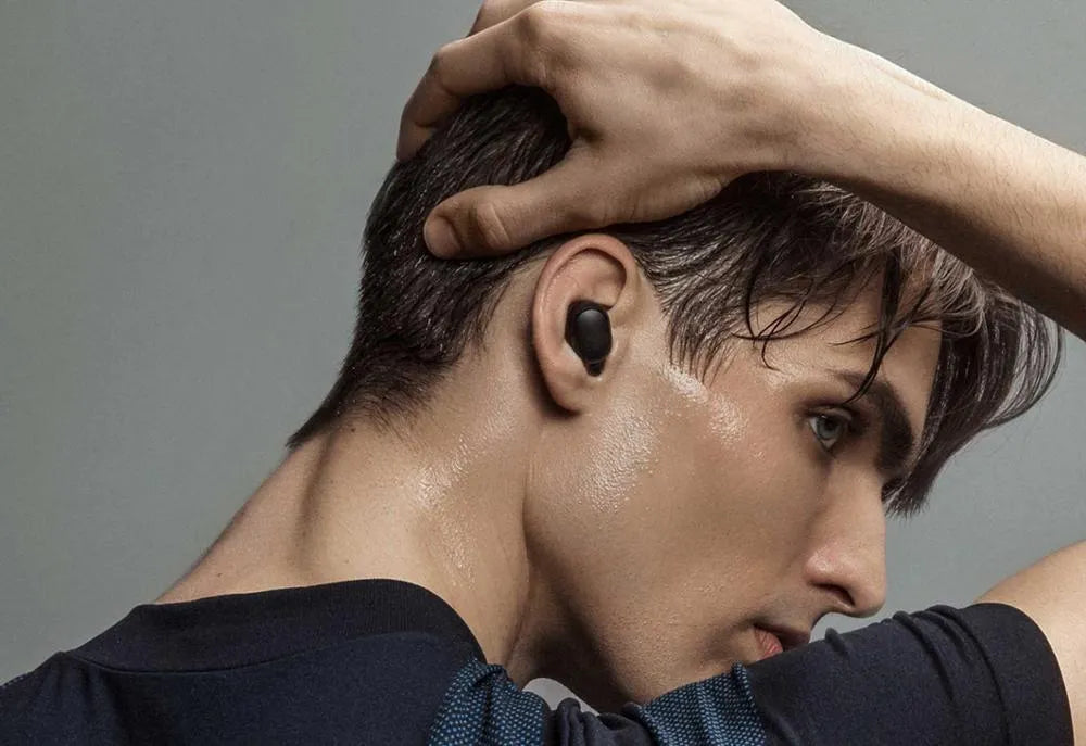 Black Redmi AirDots true wireless Bluetooth earbuds with a charging case.