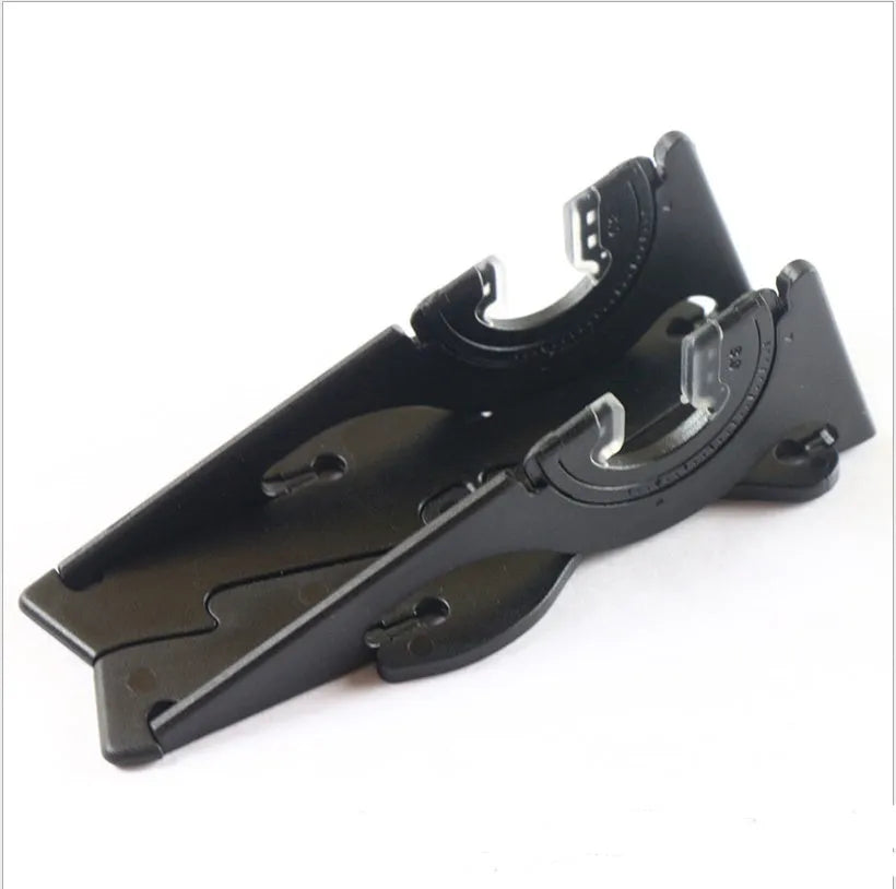 Black plastic card type mobile phone holder on a desktop, showing a phone standing upright.