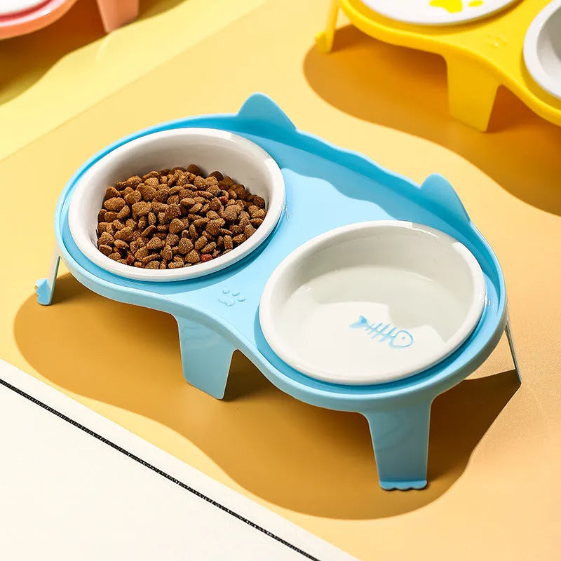 Blue ceramic cat food and water bowl set on a white elevated plastic stand with hook design.