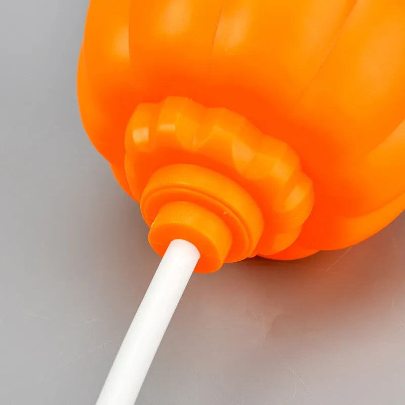 Plastic pumpkin-shaped decorative lamp with USB cable, showing yellow or purple LED light option.