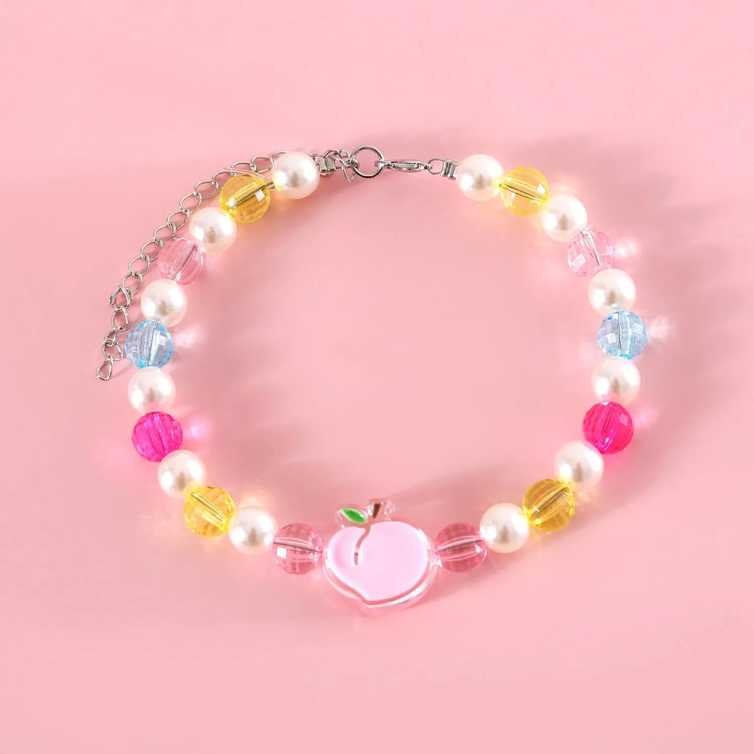 Colourful plastic bead pet necklace in small flower, rainbow, or peach design on an adjustable collar