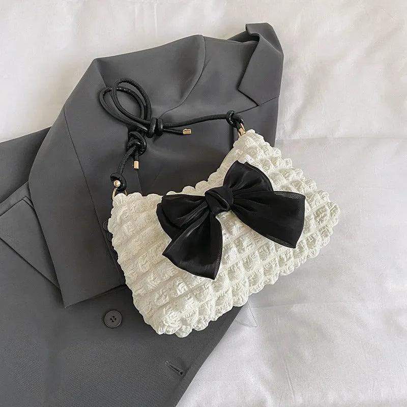 Women's canvas one-shoulder handbag in horizontal square shape with sandwich pocket, shown in black colour