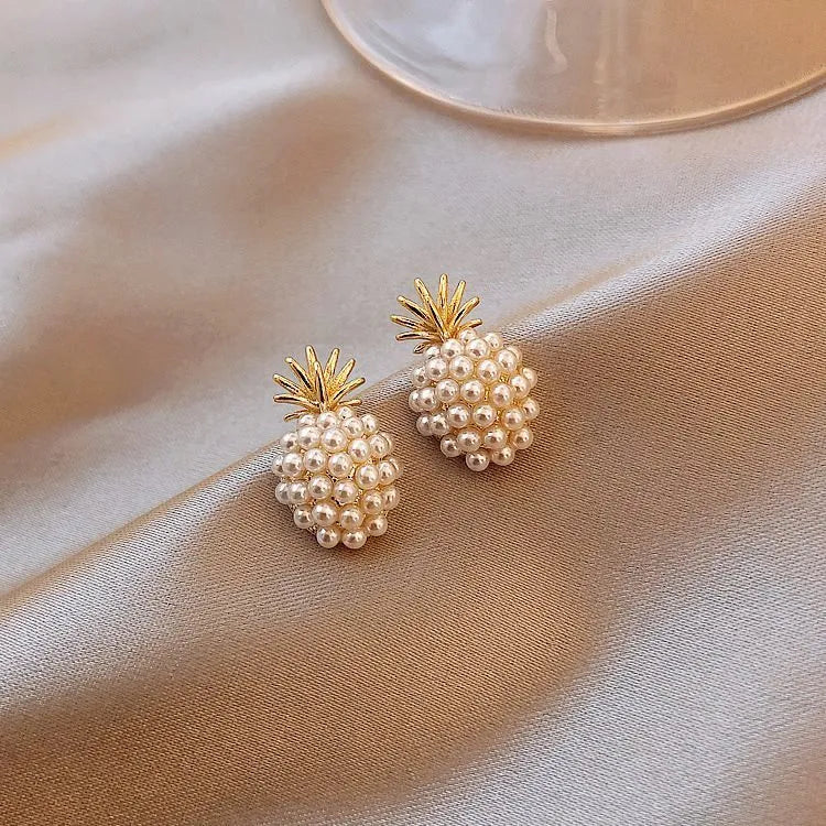 Gold pineapple and starfish pearl Korean style drop earrings with alloy electroplating and inlaid gems.
