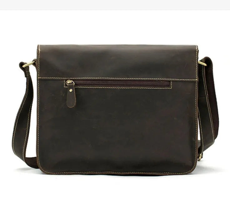 Brown full-grain leather vintage messenger bag with brass hardware, showing front flap and adjustable crossbody strap.