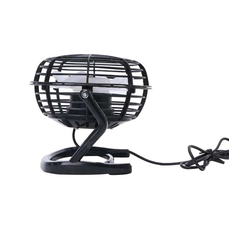 Small black and white USB desk fan with adjustable angle on a wooden table.