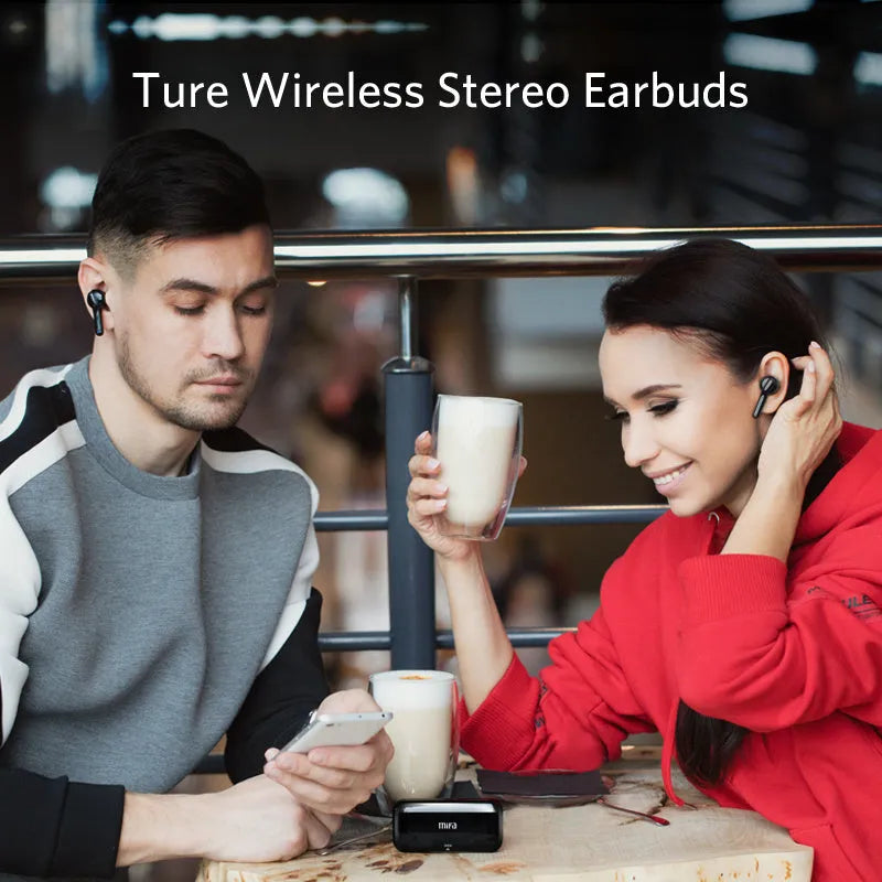 Black and white true wireless stereo earbuds with a charging case on a table