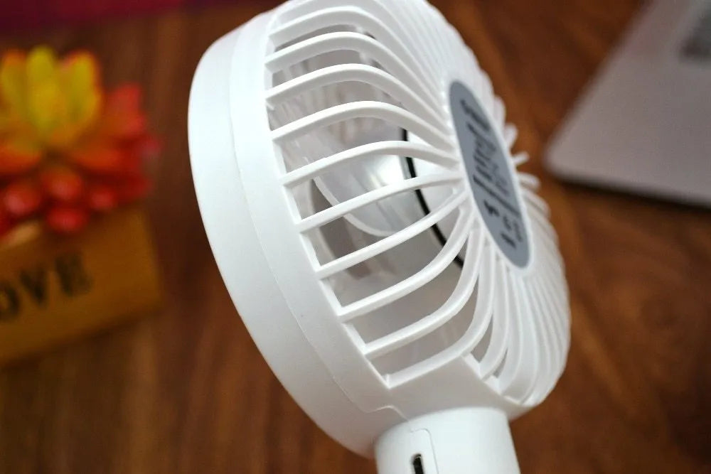 White ORICO FH1 portable USB rechargeable desk fan with three-speed buttons and compact handheld design.
