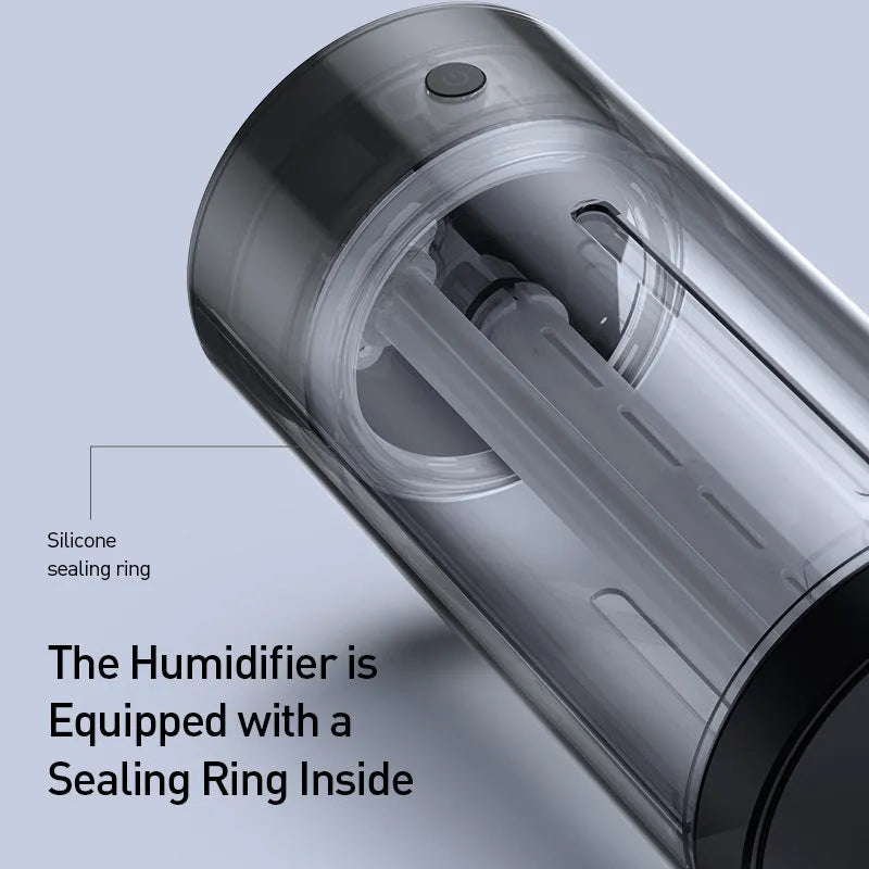 Black aluminium alloy car humidifier with USB cable and 12V car adapter plug on a desk.