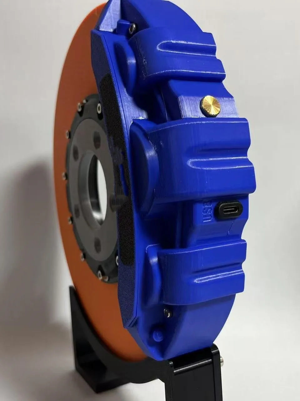 Brake disc themed LED desktop night light in blue caliper colour with touch control