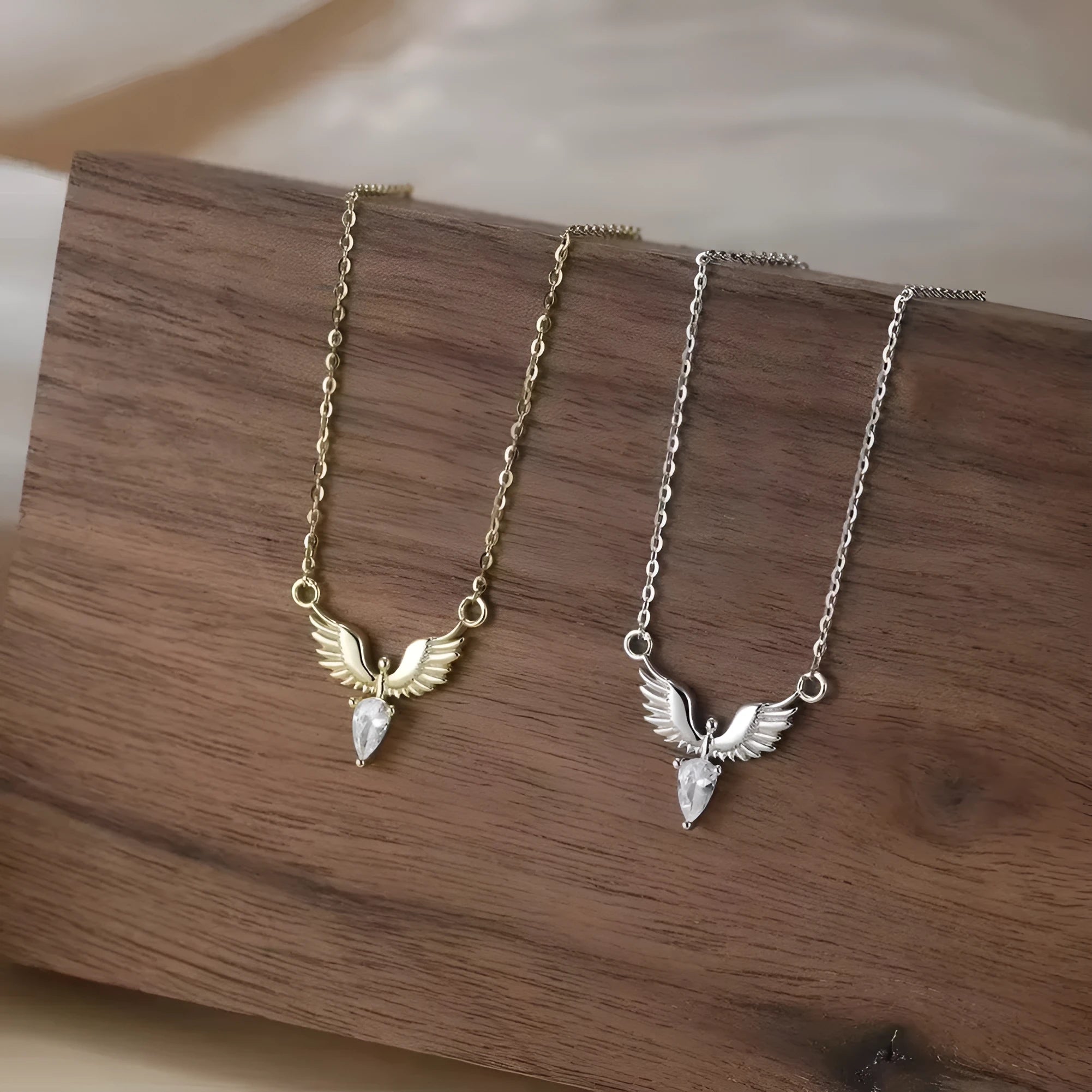 Women's silver eagle pendant necklace on an O-ring chain, shown in white gold and yellow gold electroplated finishes.