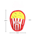 Colourful crinkle and squeak dog toy in a fast-food burger shape on a white background.