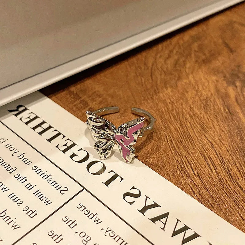 Creative butterfly design women's ring in copper with oil drip finish, showing an open loop style.