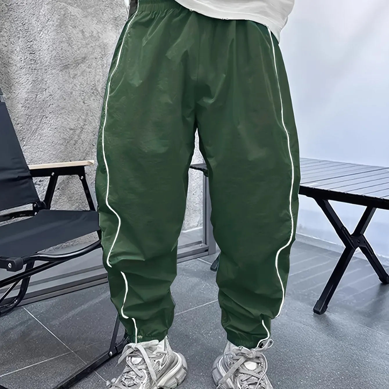 Men's blue bamboo fibre casual sports trousers with cropped length and loose fit on a hanger.