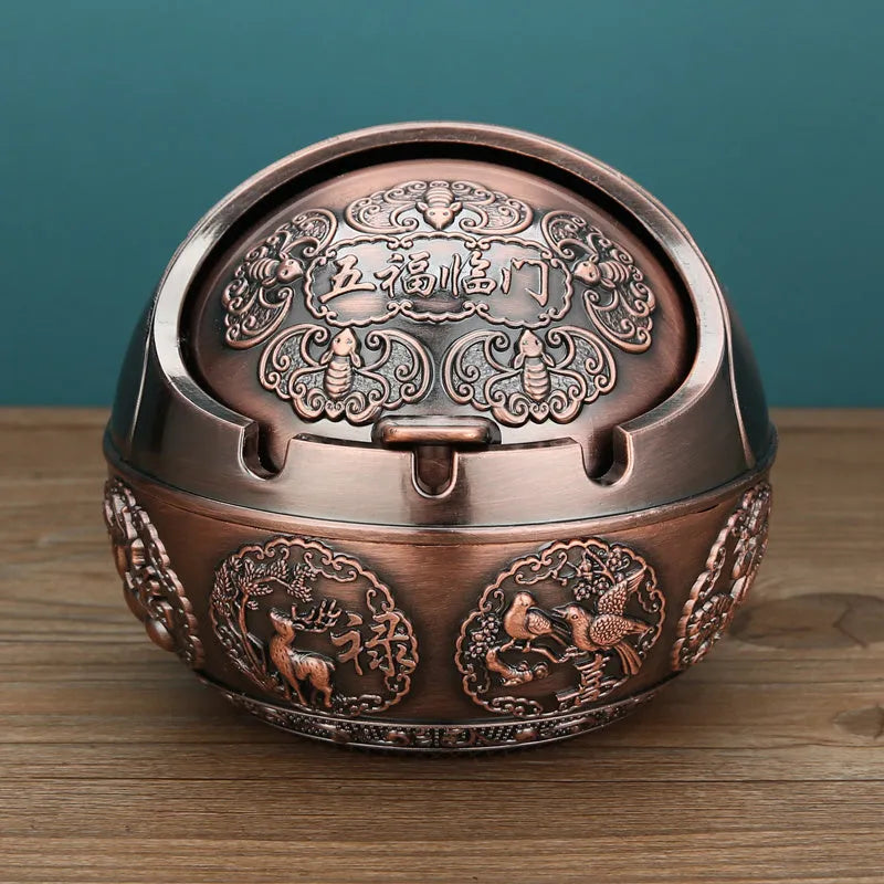 Bronze alloy ashtray with decorative fortune tree design and smoke extinguishing slot.