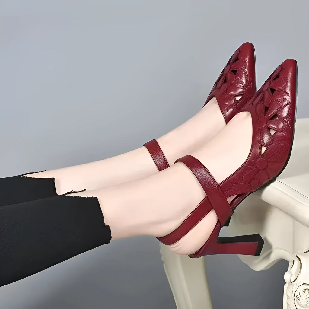 Women's red pointed toe backless sandals with high heel and hollowed toe box detail on a white background.